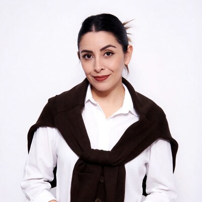 Latina woman in white shirt brown cardigan