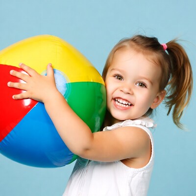 Girl holding colorful beach ball