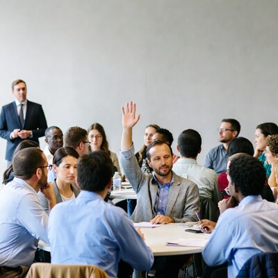 Man raising hand in business meeting