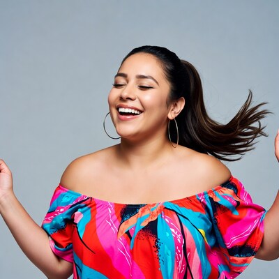 Latina woman laughing with flowing hair
