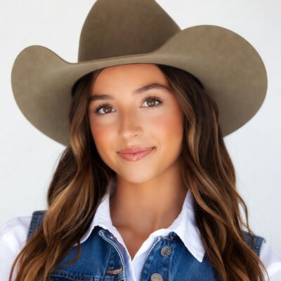 Girl in cowboy hat and denim vest