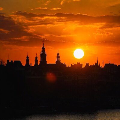 Sunset over Dutch city skyline