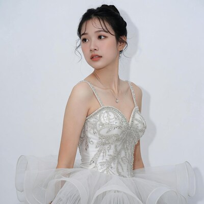 Asian woman in white tutu dress