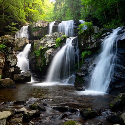 Majestic multi-tiered waterfall in lush forest
