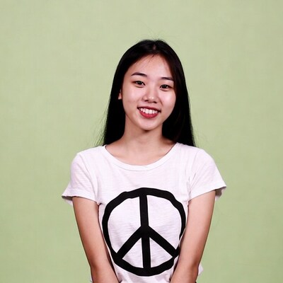 Asian woman smiling in peace sign t-shirt