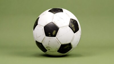 Worn Soccer Ball on Green Field