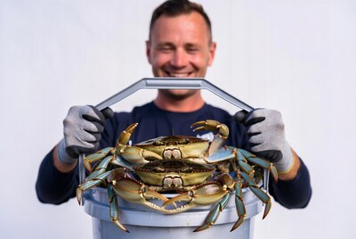 Man holding bucket of crabs