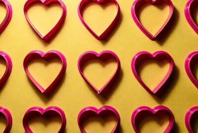 Pink heart cookie cutters on yellow