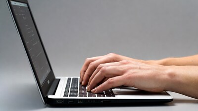 Hands typing on laptop keyboard