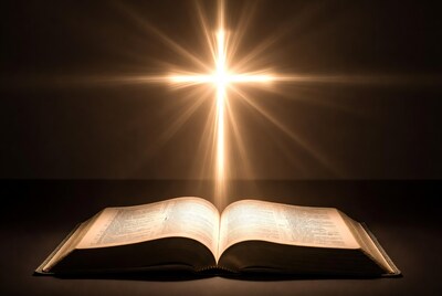 Open Bible with Glowing Cross
