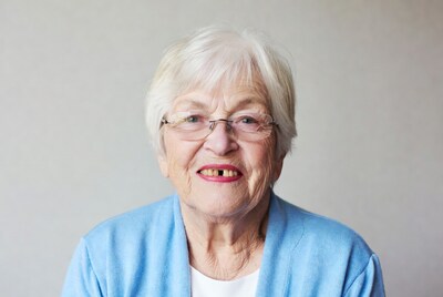 Elderly woman smiling with glasses