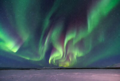 Vibrant Northern Lights over Snowy Landscape