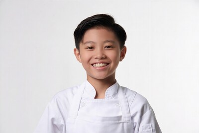 Asian boy chef smiling in uniform
