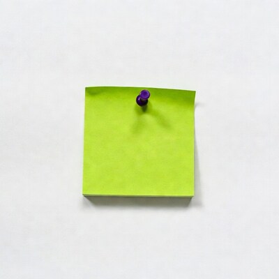 Green sticky note with purple pushpin
