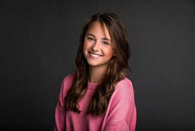Smiling girl in pink sweater