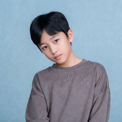 Asian boy tilting head smiling