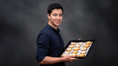 Young man holding tray of cookies