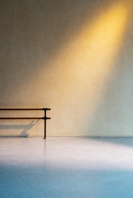 Ballet barre on wall with golden light