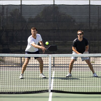 Two men playing pickleball on court