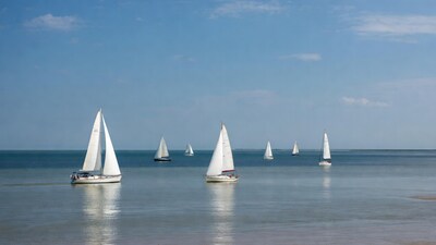 White sailboats on calm sea