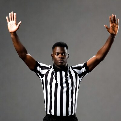 African-American referee raising both hands