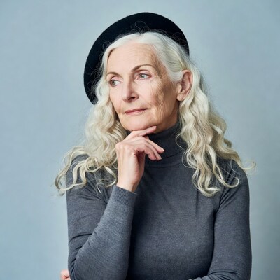 Elderly woman in beret chin resting