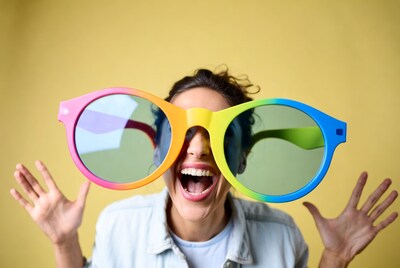 Woman wearing oversized rainbow sunglasses