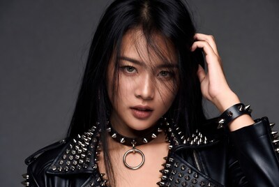 Asian woman in spiked leather jacket