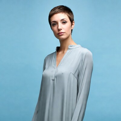 Woman with short hair in gray blouse