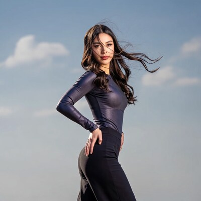 Asian woman in shiny top with flowing hair