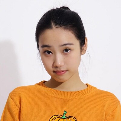 Asian girl in orange pumpkin sweater