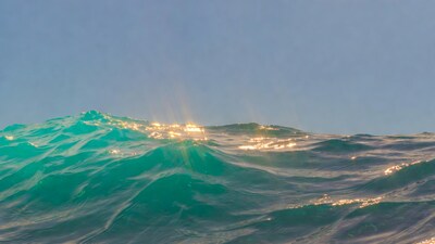 Turquoise ocean waves with sunlight