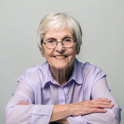 Elderly woman smiling with arms crossed