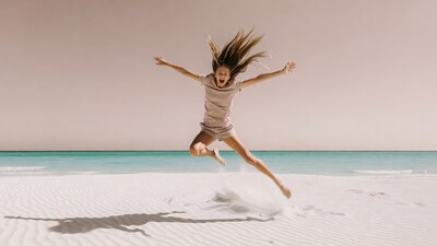 Woman jumping on beach