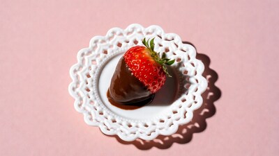 Chocolate covered strawberry on plate