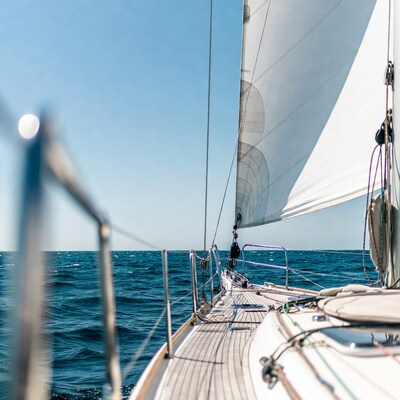 Sailboat deck with sails and ocean