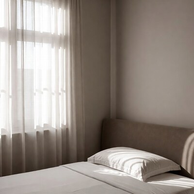 Bedroom with sheer curtains and bed