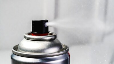 Silver spray can spraying mist