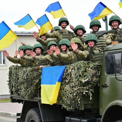 Ukrainian soldiers waving flags on truck