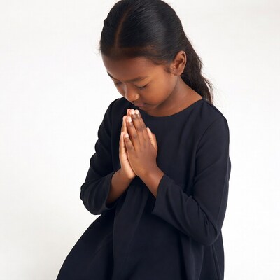 Asian girl praying with hands together