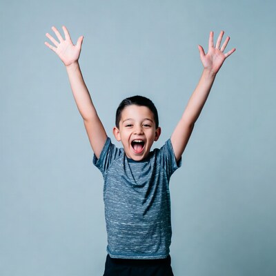 Boy raising arms excitedly