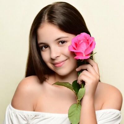 Girl holding pink rose