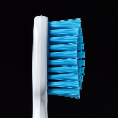 Blue bristle toothbrush side view