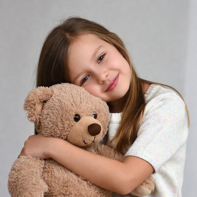 Girl hugging teddy bear