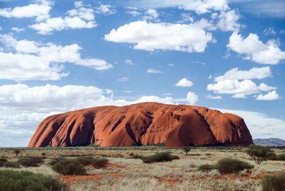 Uluru under blue sky with clouds