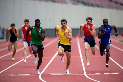 Men sprinting on red track stadium
