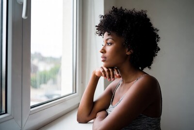 African-American woman gazing out window
