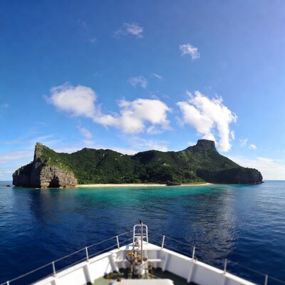 Tropical island with cliffs from boat