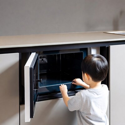 Asian boy opening microwave oven