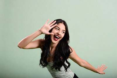 Excited woman making heart shape